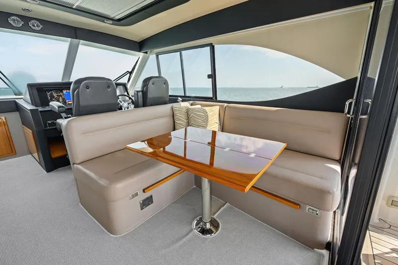 Slide: The Image of Luxurious interior of 2016 Maritimo M58 yacht with plush seating and polished wood table. - 28
