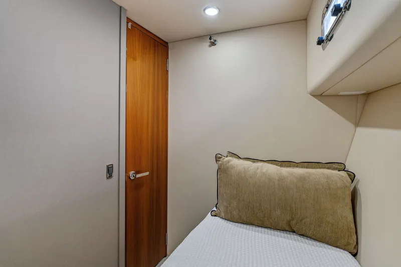 Slide: The Image of 2016 Maritimo M58 yacht interior cabin with bed and wooden door. - 53