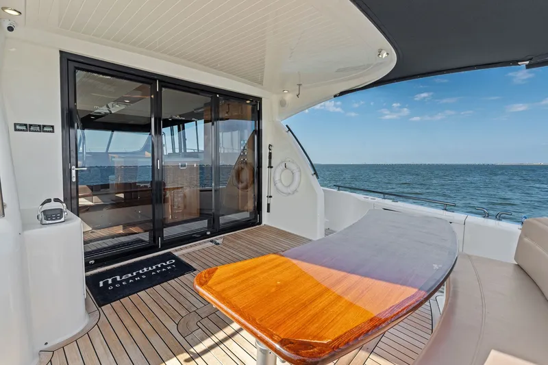 Slide: The Image of 2016 Maritimo M58 yacht deck with ocean view and elegant seating area. - 6