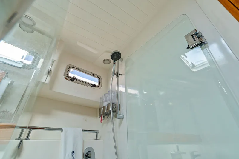 Slide: The Image of Luxurious shower area in 2016 Maritimo M58 yacht with modern fixtures and porthole window. - 50