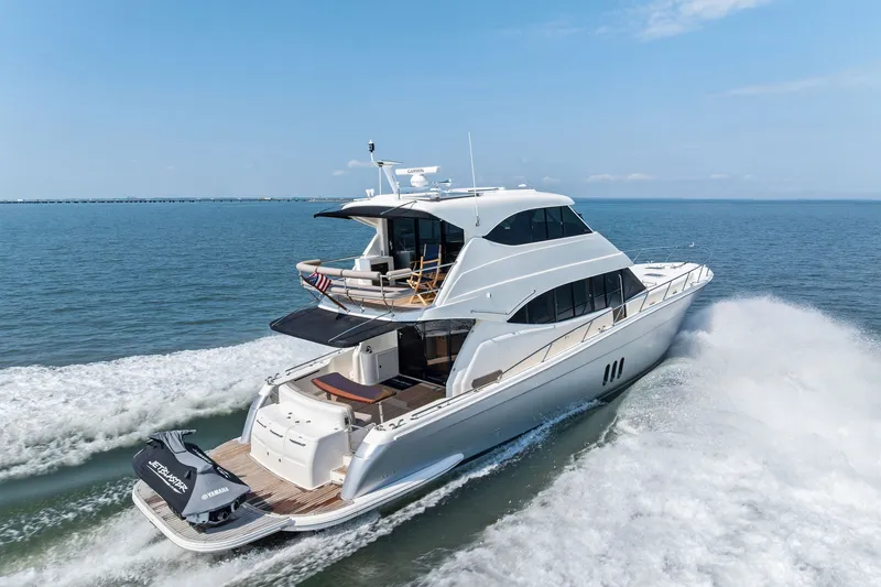 Slide: The Image of 2016 Maritimo M58 yacht cruising on open water, showcasing sleek design and luxury features. - 65