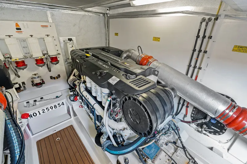 Slide: The Image of Engine room of a 2016 Maritimo M58 yacht, showcasing detailed machinery and components. - 56