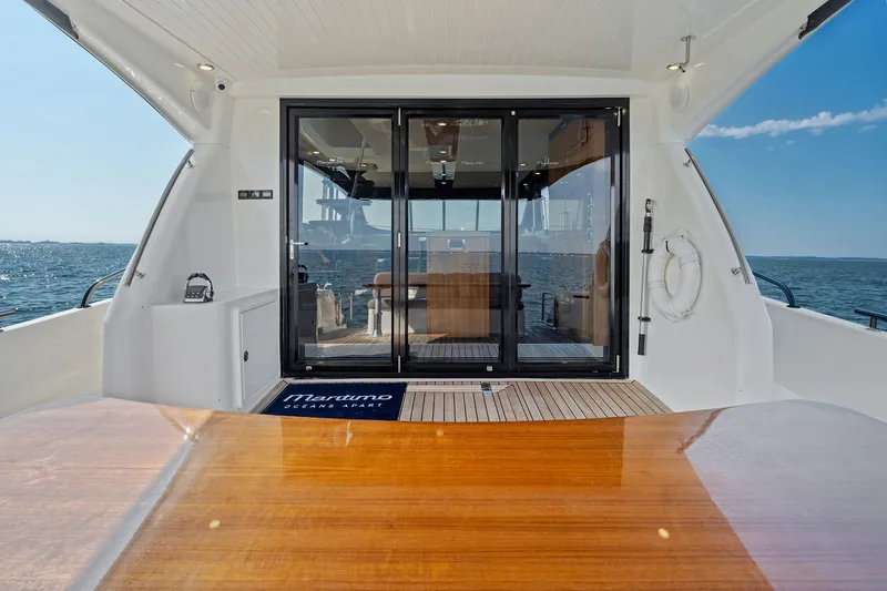 Slide: The Image of 2016 Maritimo M58 yacht deck with ocean view and sliding glass doors. - 10