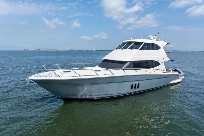 Slide: The Image of 2016 Maritimo M58 yacht cruising on open water under a clear blue sky. - 3