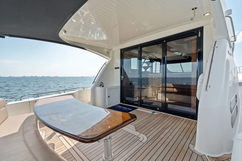 Slide: The Image of Luxury 2016 Maritimo M58 yacht deck with ocean view and elegant seating area. - 9