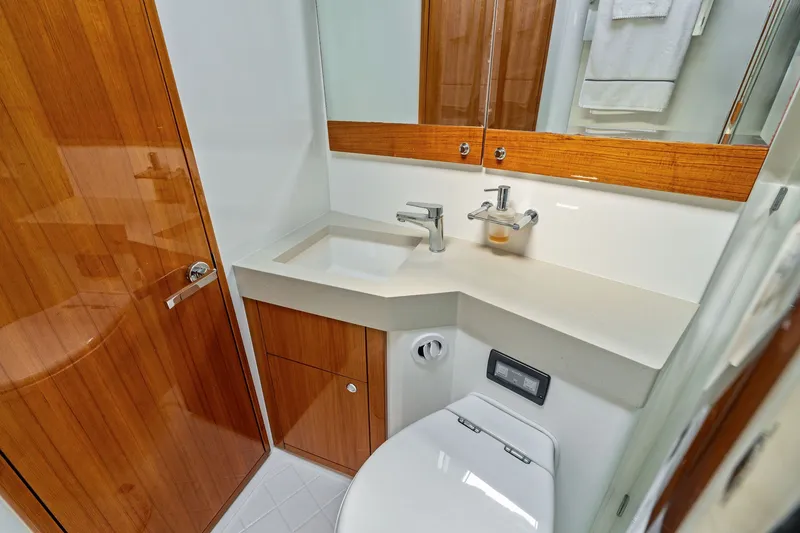 Slide: The Image of Luxurious bathroom in 2016 Maritimo M58 yacht with modern fixtures and wooden accents. - 51