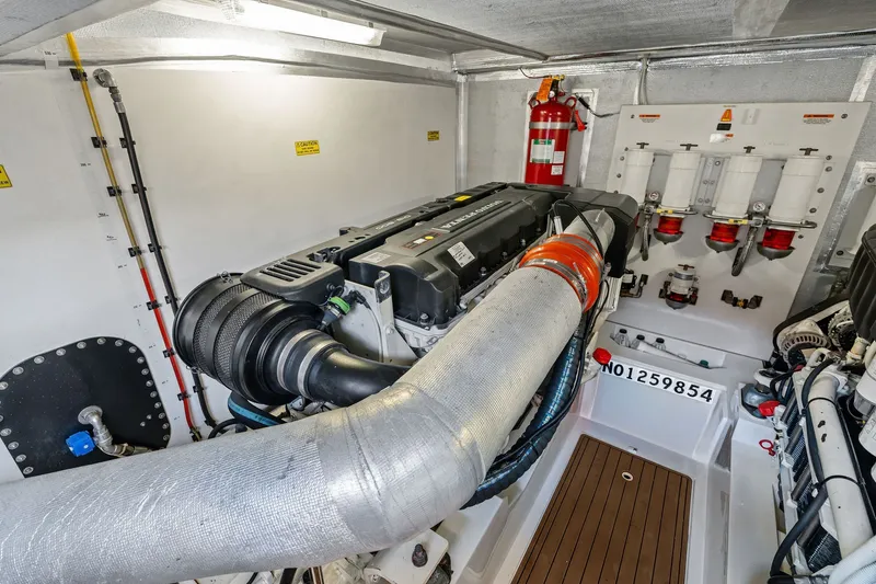 Slide: The Image of Engine room of a 2016 Maritimo M58 yacht, featuring a powerful engine setup. - 63