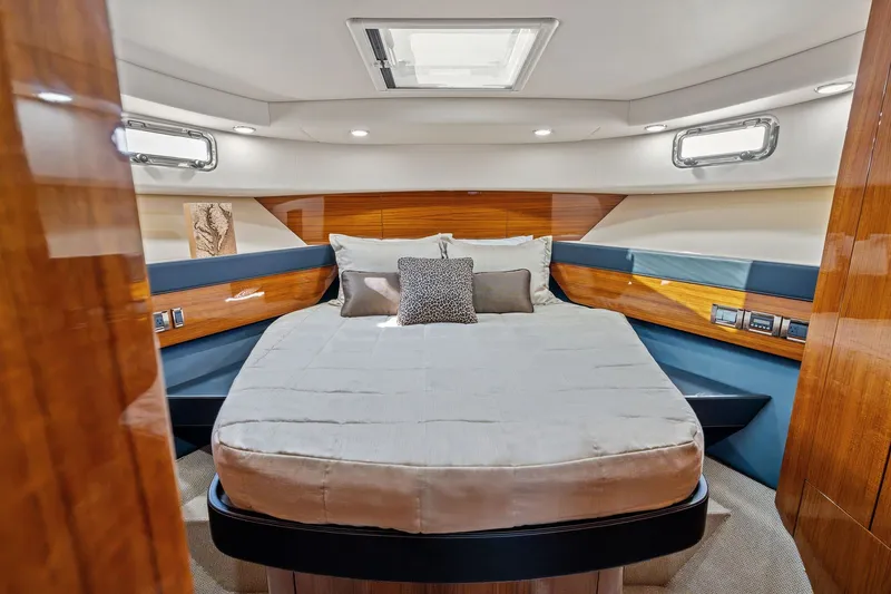 Slide: The Image of Luxurious 2016 Maritimo M58 yacht bedroom with elegant wood finishes and modern lighting. - 46