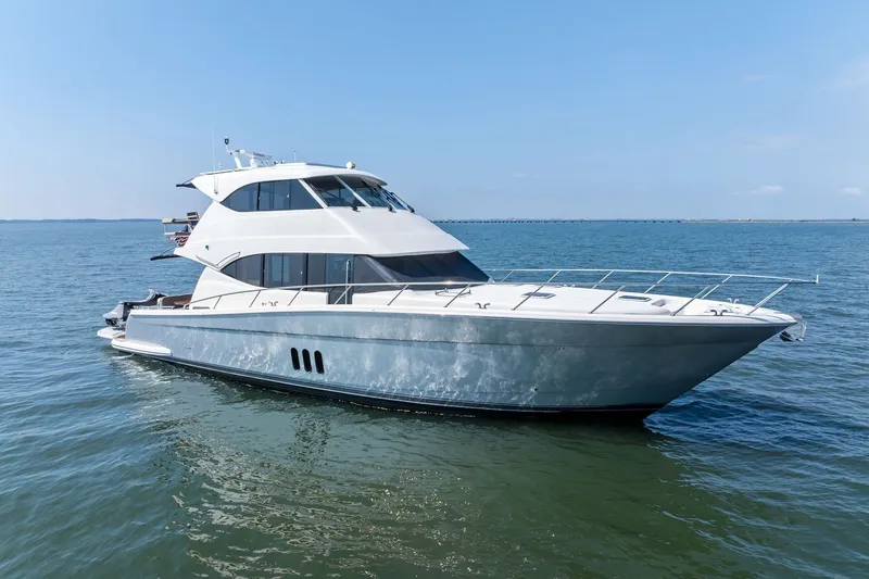 Slide: The Image of 2016 Maritimo M58 yacht cruising on open water under clear blue skies. - 1