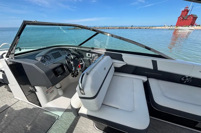 Slide: The Image of 2017 Regal 2800 Bowrider interior with steering wheel, seating, and scenic waterfront view. - 8
