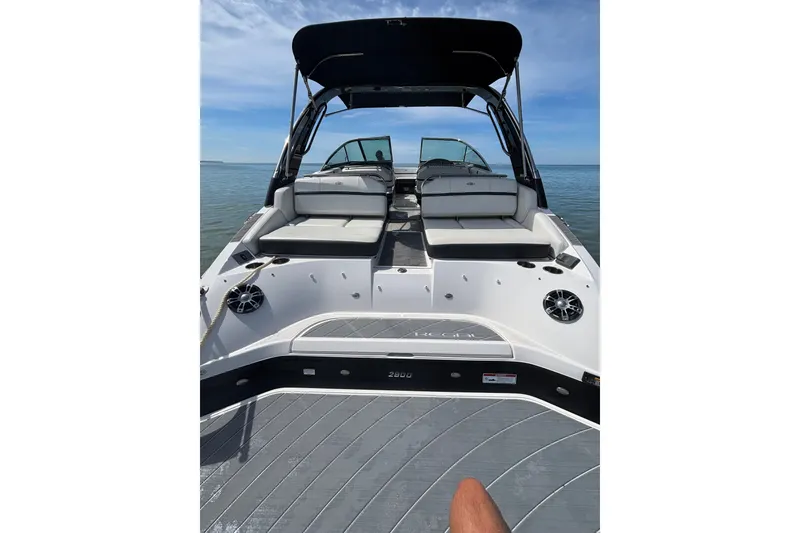 Slide: The Image of 2017 Regal 2800 Bowrider boat with spacious seating on calm water. - 13