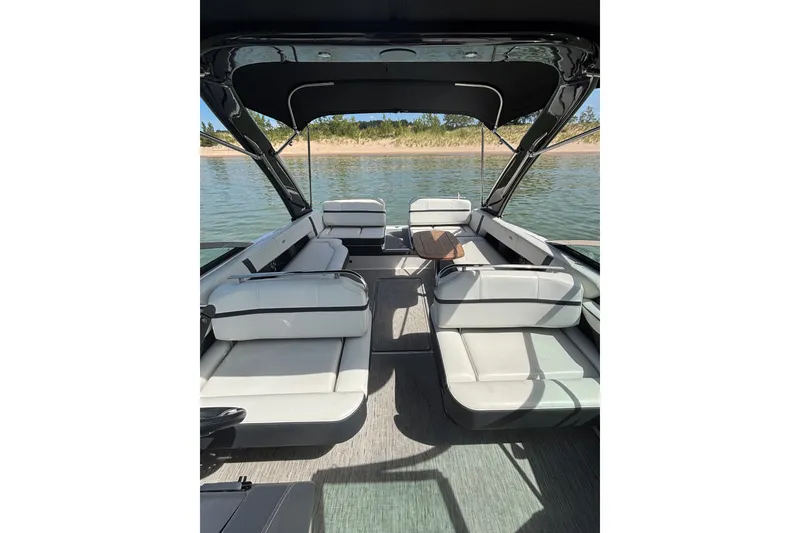 Slide: The Image of 2017 Regal 2800 Bowrider interior with spacious seating and elegant design on calm water. - 12