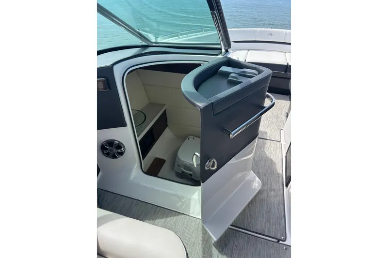 Slide: The Image of 2017 Regal 2800 Bowrider interior with open door revealing cabin and toilet. - 15