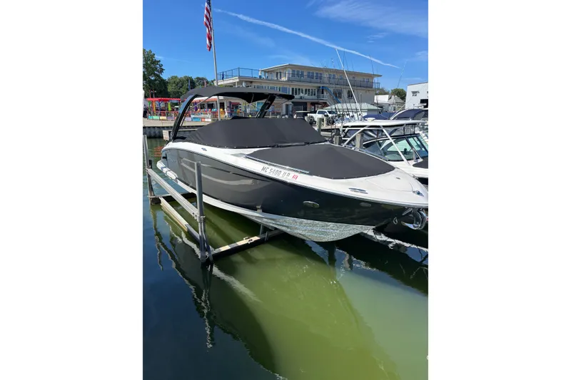 Slide: The Image of 2017 Regal 2800 Bowrider boat docked at marina under clear blue sky. - 3