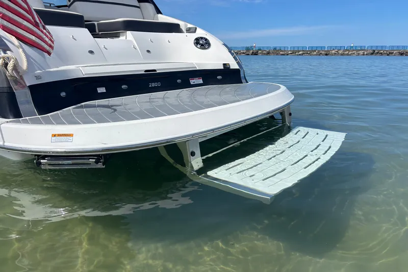 Slide: The Image of 2017 Regal 2800 Bowrider with swim platform in clear water, rear view. - 2