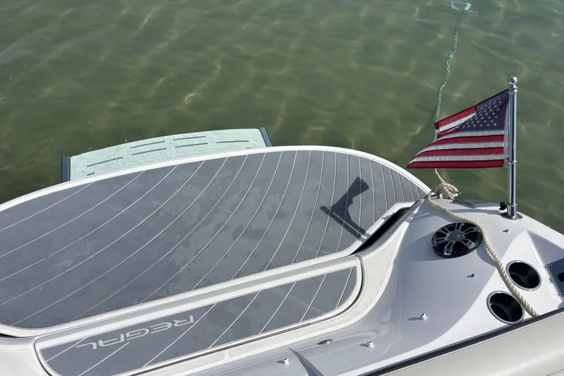 Slide: The Image of 2017 Regal 2800 Bowrider boat with American flag on calm water. - 22