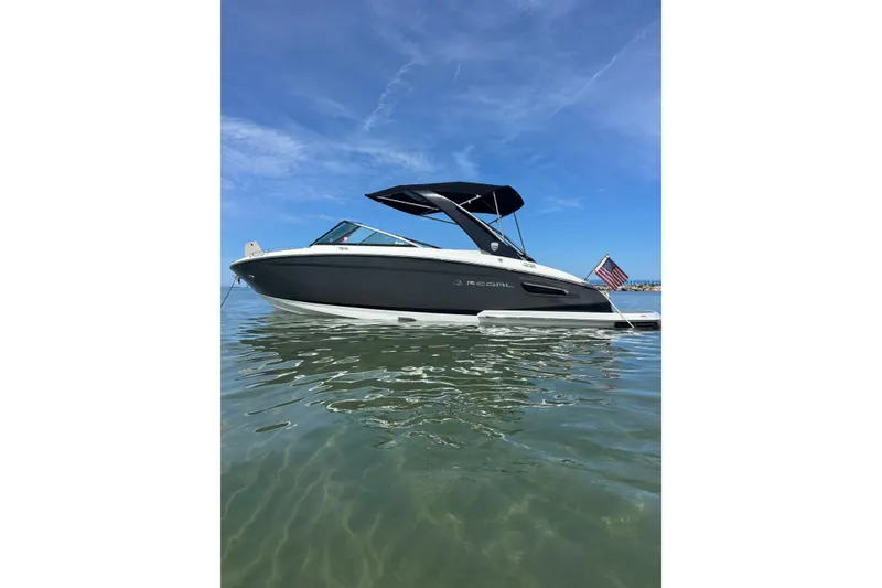 The Image of 2017 Regal 2800 Bowrider boat on calm water under clear blue sky. - 0