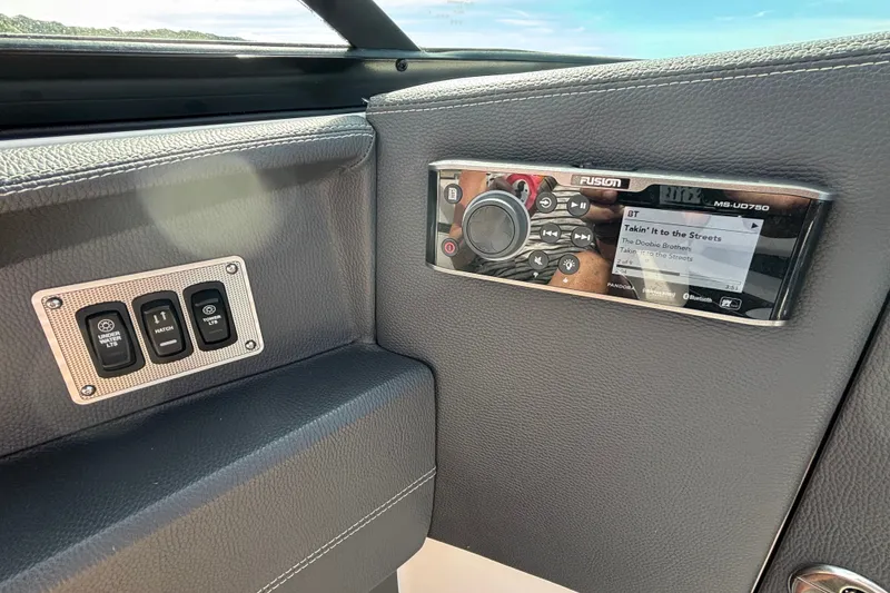 Slide: The Image of Control panel and stereo system on a 2017 Regal 2800 Bowrider boat. - 18