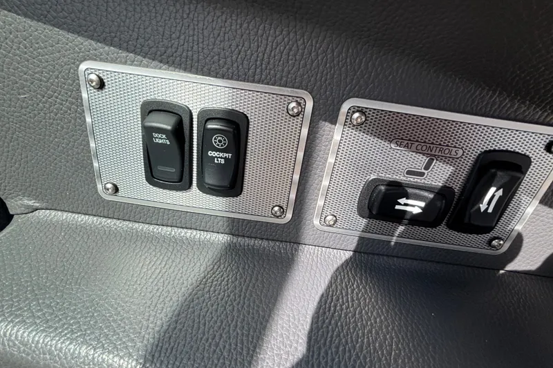 Slide: The Image of Control panel of a 2017 Regal 2800 Bowrider with dock and cockpit light switches. - 21