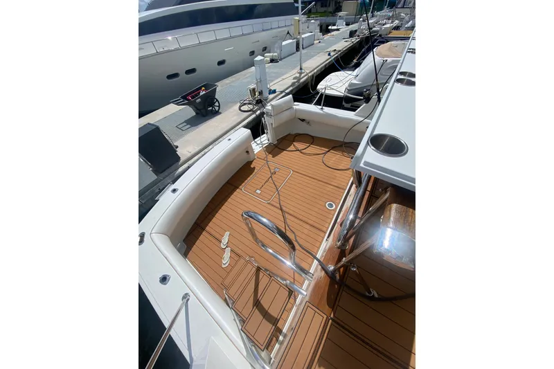 Slide: The Image of 1990 Hatteras 67 Cockpit Motor Yacht with spacious teak deck at marina. - 3