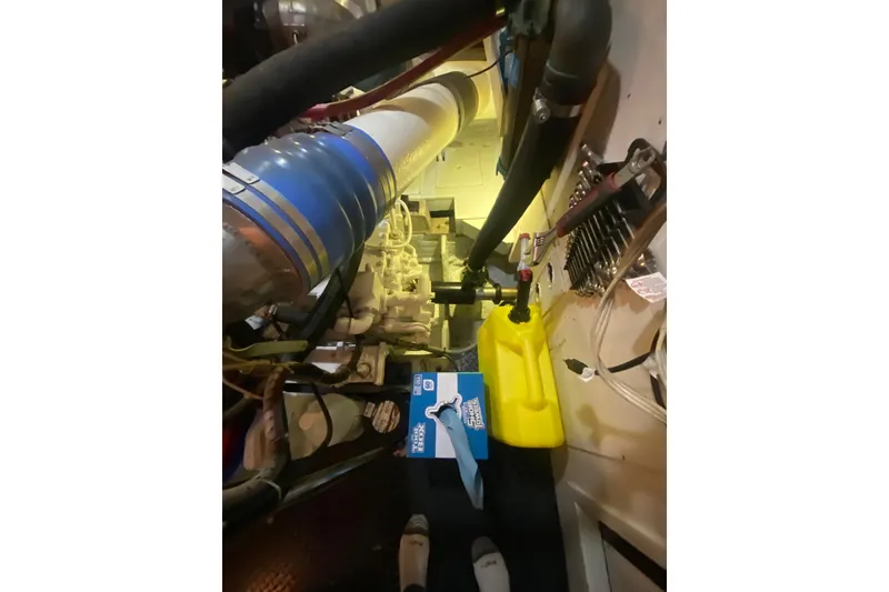 Slide: The Image of Engine room of 1990 Hatteras 67 Cockpit Motor Yacht with visible components and equipment. - 16
