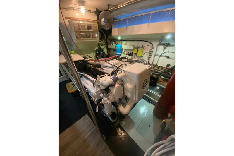 Slide: The Image of Engine room of 1990 Hatteras 67 Cockpit Motor Yacht, showcasing machinery and equipment. - 21