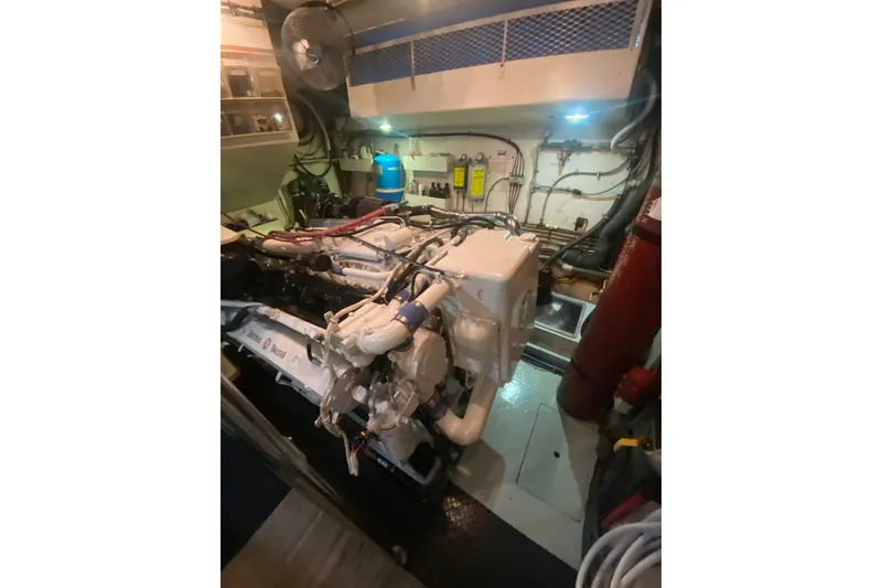 Slide: The Image of Engine room of 1990 Hatteras 67 Cockpit Motor Yacht, showcasing machinery and equipment. - 19