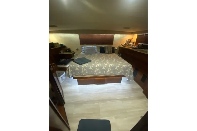 Slide: The Image of Cozy bedroom interior of 1990 Hatteras 67 Cockpit Motor Yacht with bed and wooden furnishings. - 10