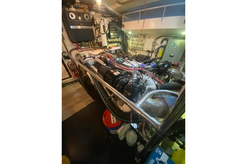 Slide: The Image of Engine room of 1990 Hatteras 67 Cockpit Motor Yacht, showcasing machinery and components. - 15