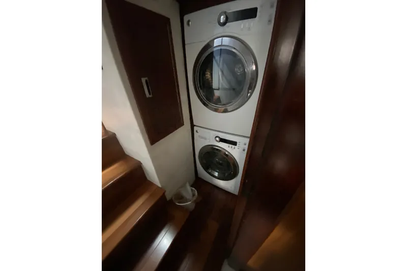 Slide: The Image of Laundry area with stacked washer and dryer in 1990 Hatteras 67 Cockpit Motor Yacht. - 23
