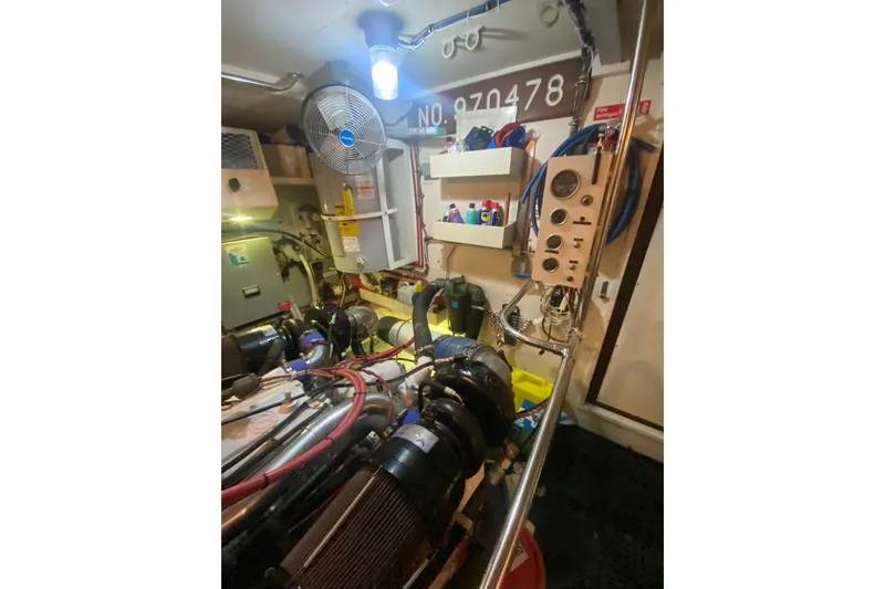 Slide: The Image of Engine room of 1990 Hatteras 67 Cockpit Motor Yacht with equipment and controls. - 17