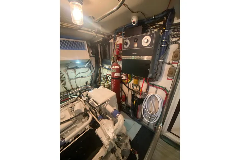 Slide: The Image of Engine room of 1990 Hatteras 67 Cockpit Motor Yacht with machinery and control panels. - 20