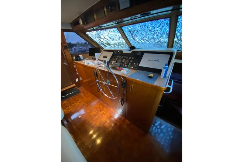 Slide: The Image of Cockpit of 1990 Hatteras 67 Cockpit Motor Yacht with steering wheel and navigation equipment. - 32