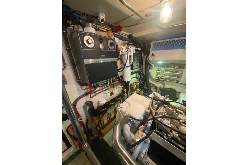Slide: The Image of Engine room of 1990 Hatteras 67 Cockpit Motor Yacht with control panel and machinery. - 18