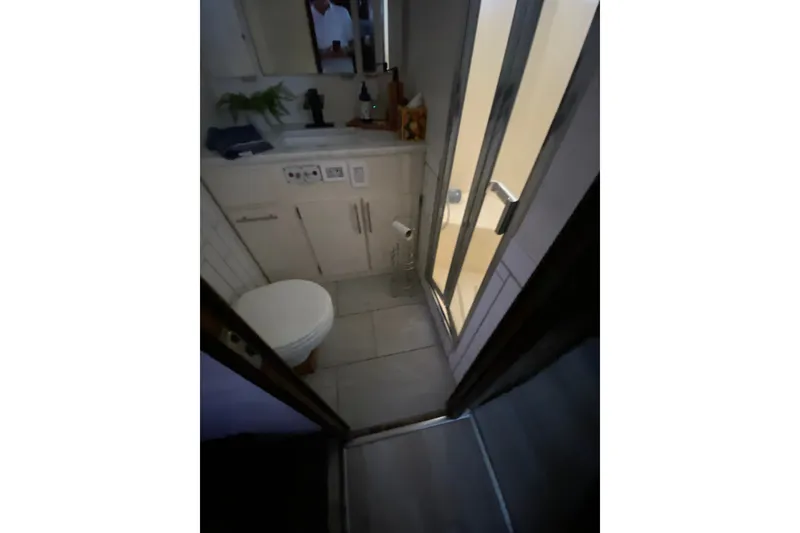 Slide: The Image of Bathroom interior of 1990 Hatteras 67 Cockpit Motor Yacht with shower and toilet. - 29