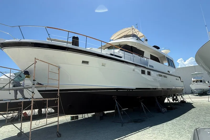 Slide: The Image of 1990 Hatteras 67 Cockpit Motor Yacht undergoing maintenance on dry dock. - 1