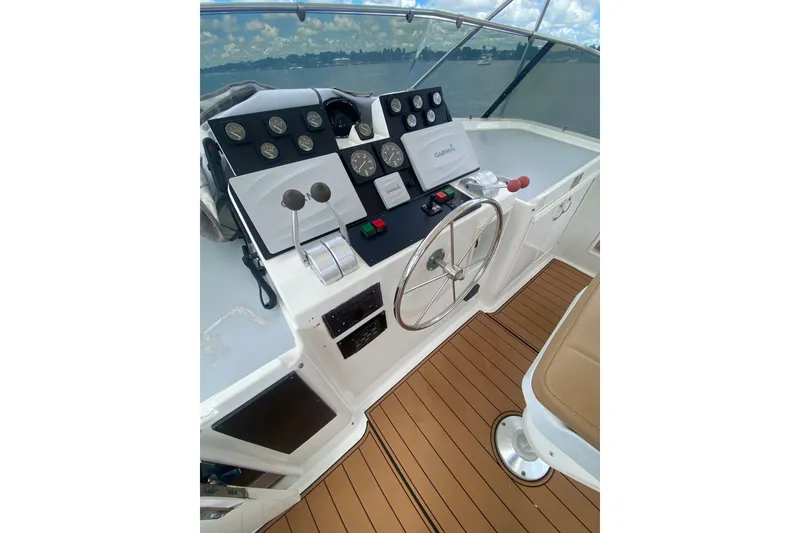 Slide: The Image of Cockpit of 1990 Hatteras 67 Cockpit Motor Yacht with steering wheel and navigation instruments. - 11