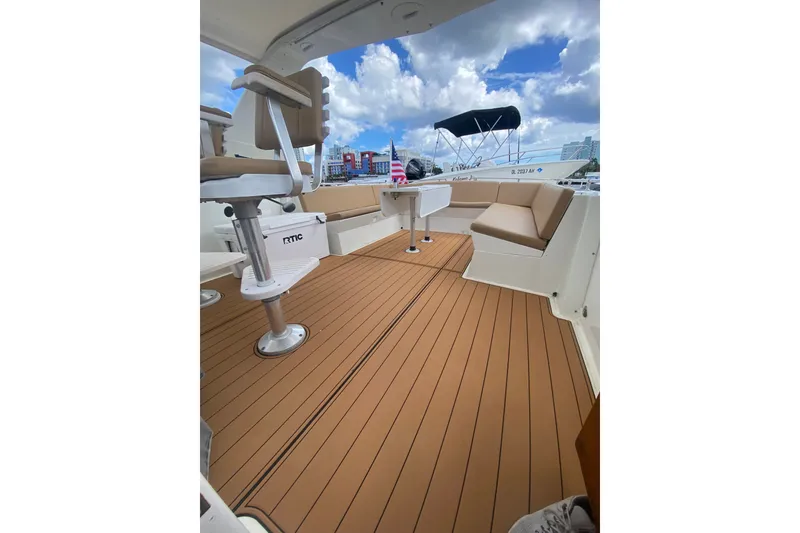 Slide: The Image of 1990 Hatteras 67 Cockpit Motor Yacht deck with seating and clear sky view. - 6