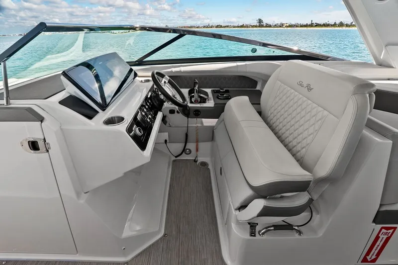 Slide: The Image of The image shows the cockpit of a 2023 Sea Ray SLX 310 Outboard with a modern helm. - 30