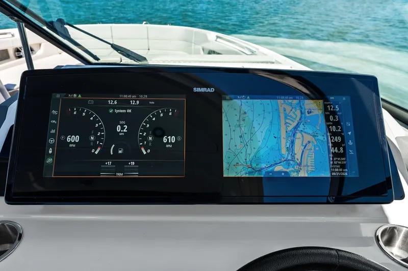 Slide: The Image of The image shows the dashboard of a Sea Ray SLX 310 Outboard with modern navigation systems. - 29