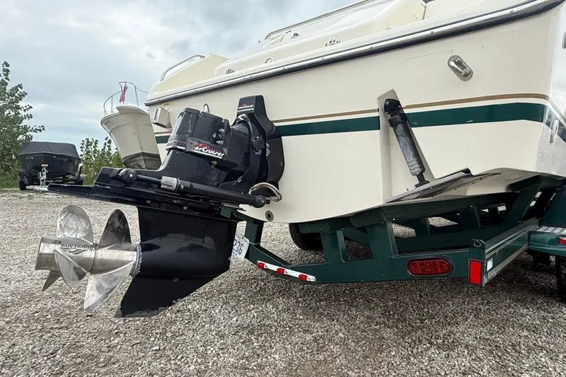 Slide: The Image of 1999 Pursuit 2460 Denali boat on trailer, featuring a powerful MerCruiser engine. - 8