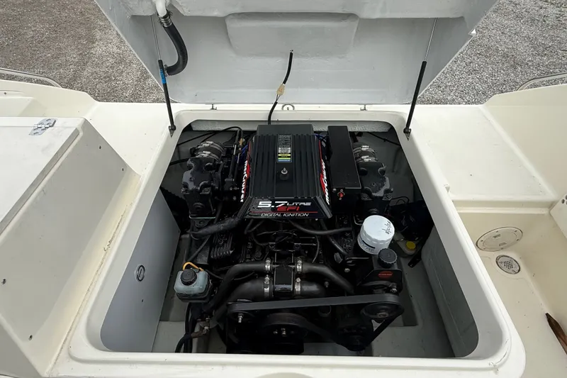 Slide: The Image of Engine compartment of a 1999 Pursuit 2460 Denali boat, showcasing a 5.7-liter engine. - 32