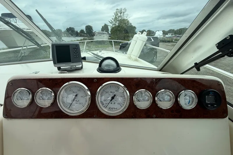 Slide: The Image of Dashboard of a 1999 Pursuit 2460 Denali boat with gauges and Garmin GPS. - 12