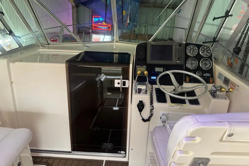 Slide: The Image of Cockpit of 2000 Pursuit 3000 Express boat with steering wheel and navigation instruments. - 8