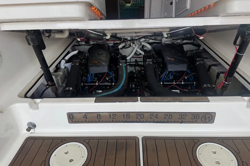 Slide: The Image of Engine compartment of a 2000 Pursuit 3000 Express boat, showcasing dual V8 engines. - 24