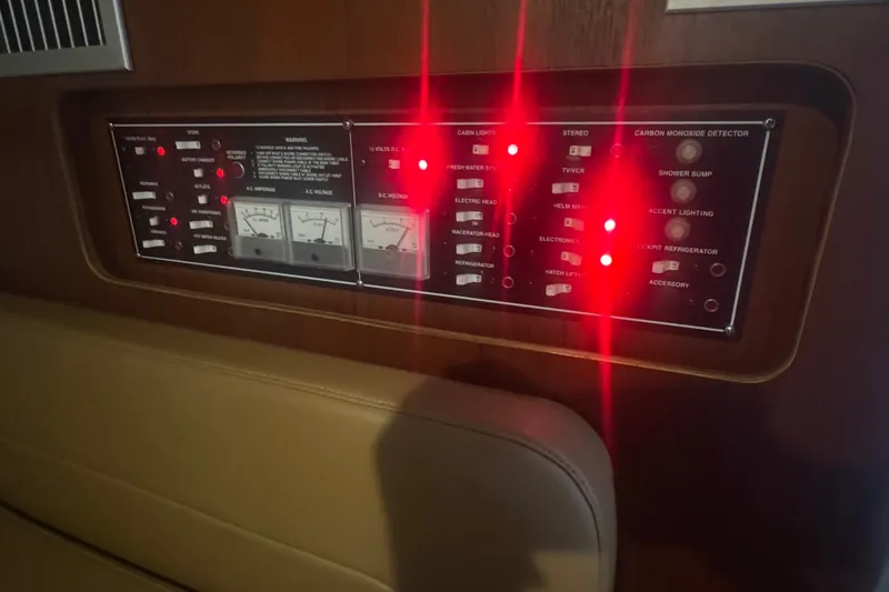 Slide: The Image of Control panel of a 2000 Pursuit 3000 Express boat with illuminated indicators. - 22