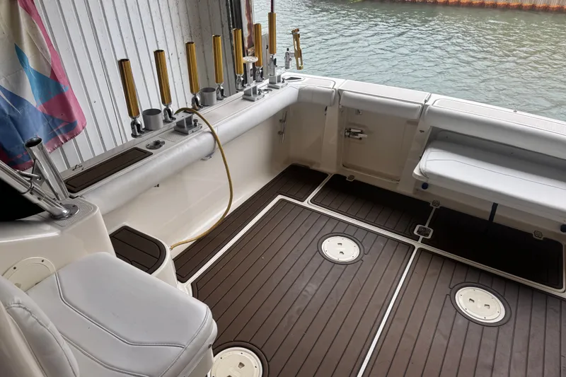 Slide: The Image of Interior of a 2000 Pursuit 3000 Express boat with rod holders and seating. - 14