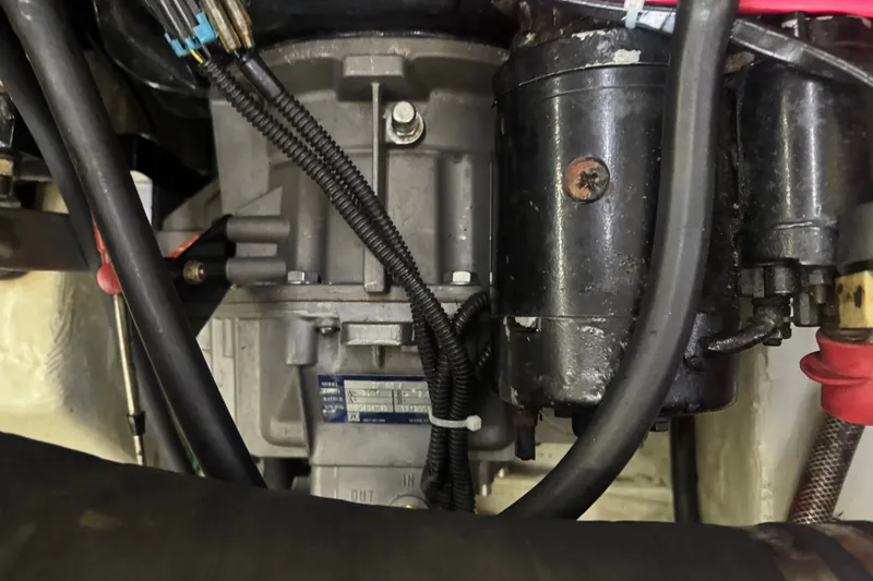 Slide: The Image of Engine compartment of a 2000 Pursuit 3000 Express boat, showing mechanical components and wiring. - 32