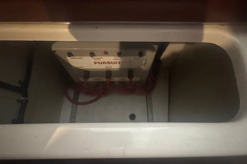 Slide: The Image of Electrical panel inside 2000 Pursuit 3000 Express boat compartment. - 34
