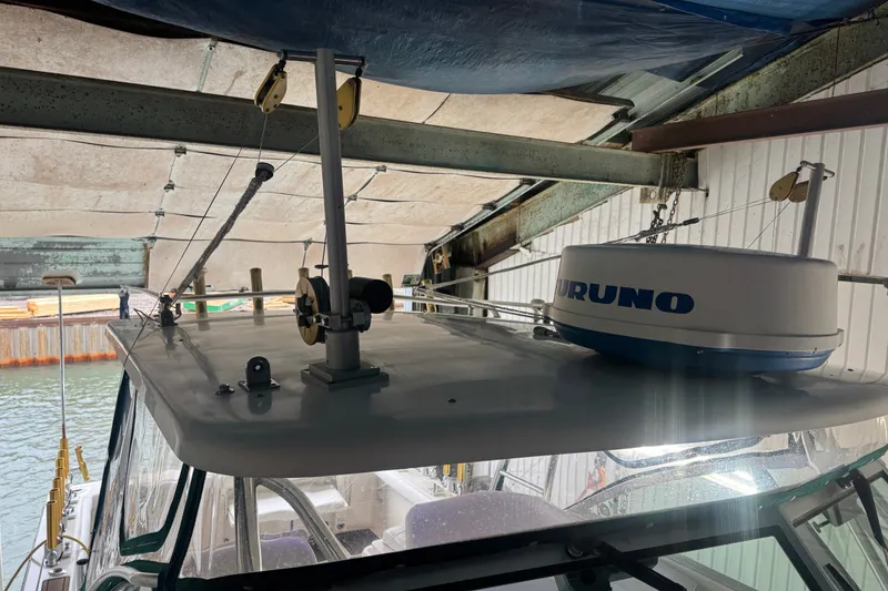 Slide: The Image of 2000 Pursuit 3000 Express boat with radar equipment in a covered dock. - 7